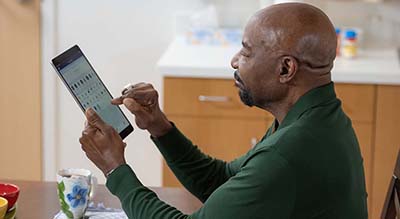 man with tablet in home